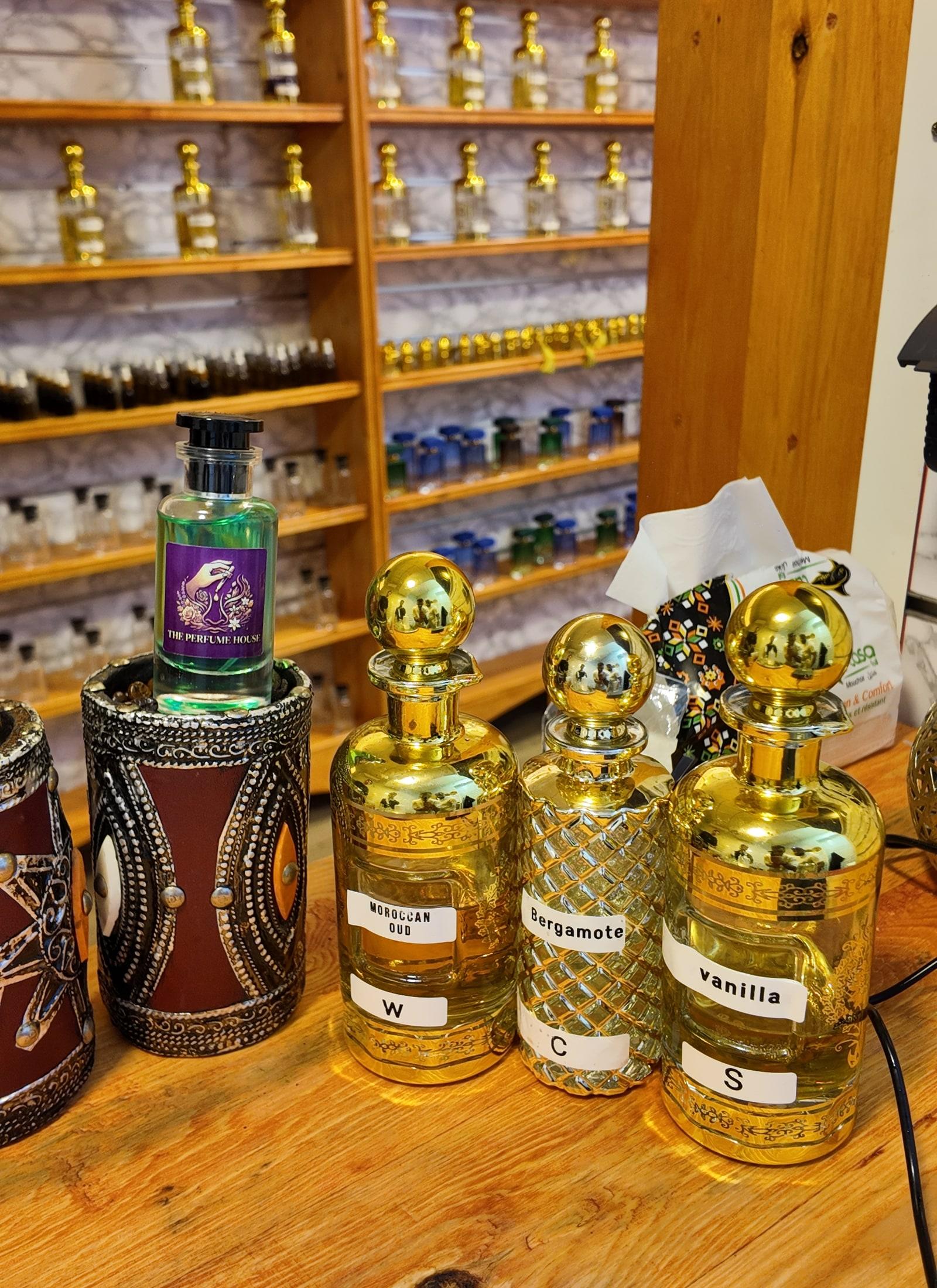 Master perfumer at The Perfume House Marrakech warmly presenting a bespoke creation
